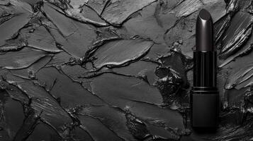 Sleek Black Lipstick on a Textured Charcoal Smear Background photo