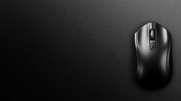 Sleek Black Computer Mouse on a Smooth Dark Surface photo