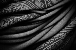 Layered Black Fabric with Intricate White Patterns and Soft Folds photo