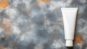 White Tube with Cap on a Gray Surface with Orange Rust Spots photo