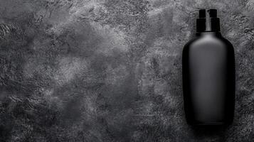 Black Spray Bottle on a Textured Gray Stone Surface photo