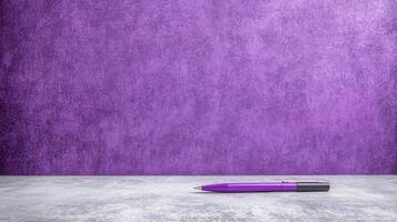 Purple Pen on a Light Gray Surface with a Vibrant Purple Wall photo