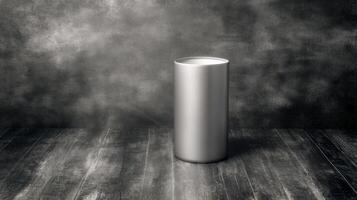 Silver Cylindrical Container on a Dark Wooden Floor with a Textured Wall Background photo