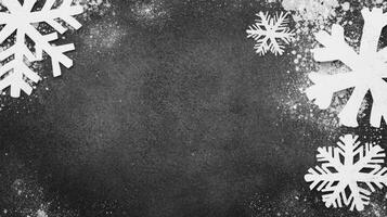 White Snowflake Cutouts with Snow Dust on a Dark Textured Background photo