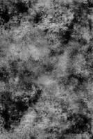 Weathered Grayscale Surface with a Mottled, Distressed Abstract Pattern photo