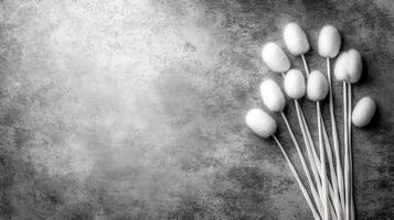 Cluster of Cotton Swabs on a Weathered Gray Stone Surface in Monochrome photo