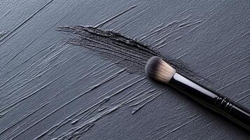 Makeup Brush with Black Smudge on a Textured Dark Surface in Monochrome photo