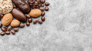 Assorted Chocolates and Almonds on a Textured Gray Surface photo