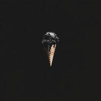 A Single Dark Ice Cream Scoop in a Waffle Cone Against a Black Background photo