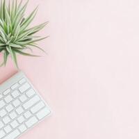 Minimalist Flat Lay of White Keyboard and Potted Plant on Pink Desk photo