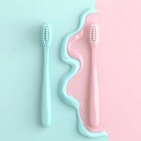 Pastel Pink and Blue Toothbrushes with a Wavy Smear Between Them photo