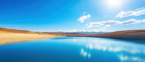 Large Dam with Low Water Levels Under Bright Blue Sky and White Clouds photo