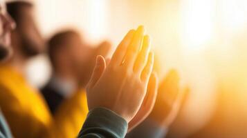 Close-Up of Hands Clapping in a Bright Environment with Soft Focus and Warm Light Background photo