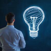 Entrepreneur Sketching Innovative Ideas on Glass Surface photo