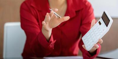 Calculating Finance Online. A professional actively engages in financial calculations while discussing reports. photo