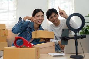 Interactive Marketing and Connectivity. A couple enthusiastically prepares their workspace for a product showcase via live stream. photo
