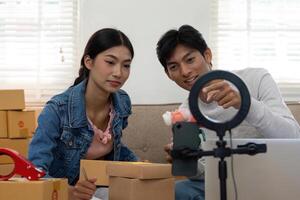 Creativity in E-Commerce. A couple discussing product features while preparing for a live unboxing session. photo