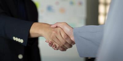 Professional Partnership and Deal Making. Close-up of a handshake between two colleagues in a business environment. photo