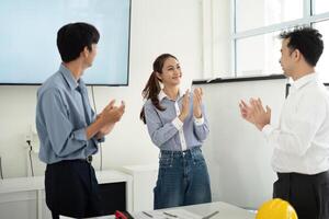 Positive Work Environment and Team Recognition. Architects and engineers applaud each other's contributions. photo