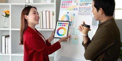 Presentation and Feedback. A designer showcases color palettes using a digital tablet to encourage creative dialogue. photo