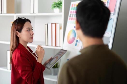 Assessment and Selection. A designer contemplates color trends while using digital tools in a modern office. photo