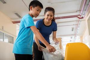 Community and Eco-Friendliness. A young person assists in recycling efforts, working together to create a cleaner environment. photo