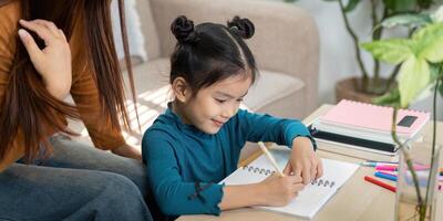 Creativity and Learning. A girl enjoys writing and drawing in her notebook with guidance. photo