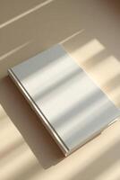 white book with subtle shadows on background, offering a clean photo