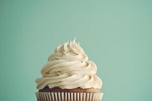 Delicious Vanilla Cupcake with Creamy Frosting on Mint Background photo