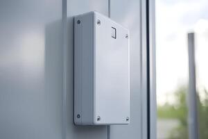 Modern White Electronic Enclosure Mounted on Gray Wall Exterior Close up photo