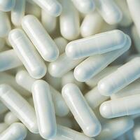 White pills are scattered on a table photo
