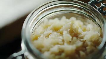 Close up of Fermented Cabbage in Glass Jar Healthy Probiotic Food Sauerkraut photo