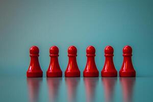Row of Red Game Pieces on Teal Background Team Unity or Competition Concept photo