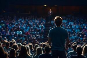Young Man Public Speaker Addressing Large Audience at Conference photo