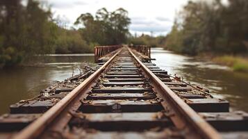 Rusty Railroad Tracks on Old Bridge Spanning River Scenic Landscape photo
