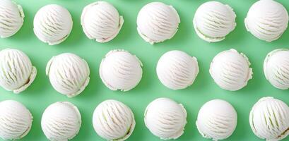 White ice cream scoops pattern on green background perfect for a summer design. photo