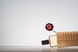 Blank beauty product in recycled delivery packaging. Minimalist mockup with dry flower photo
