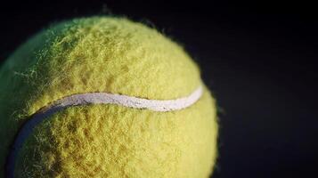 Close-Up of a Fuzzy Tennis Ball Against a Dark Background photo