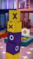 Colorful Stacked Blocks in Children's Play Area with X and O Symbols for Interactive Fun photo