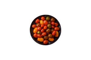Tomatoes of different colors as a vegetable meal isolated on white photo