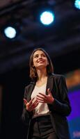 Woman giving a presentation, expressing an idea with hands raised in a professional setting. photo
