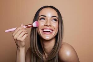 Woman Applying Blush A radiant smile illuminates her face as she adds a touch of color with a brush. photo