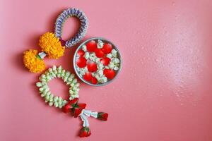 Jasmine garlands top view on pink color background with copy space. photo