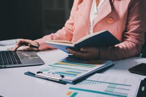 A woman is sitting at a desk photo