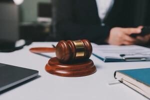 Lawyer and judge sitting at desk with a gavel and a laptop photo