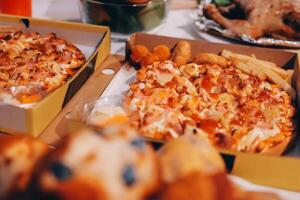 A table with two boxes of pizza and a turkey photo