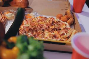 A pizza and fries in a box photo