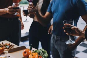 People toasting with wine glasses at a party photo