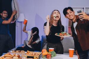 A group of people having a party with food and drinks photo