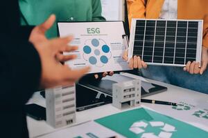 People holding up a solar panel and a paper with the words ecg on it photo